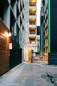 Empty alley amidst buildings in city