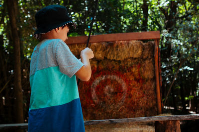 Kid aiming woith bow and arrow