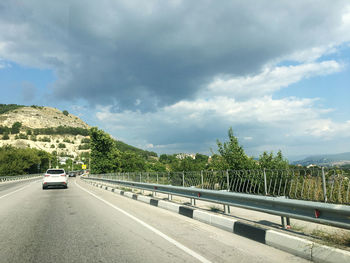 Cars on road against sky