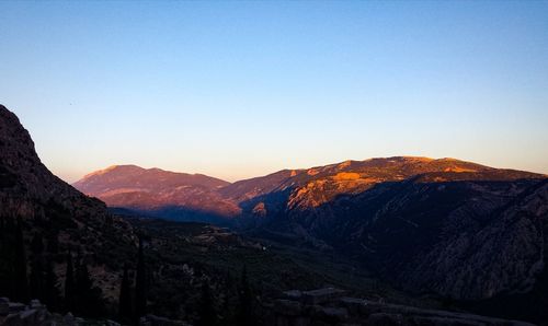 Scenic view of mountains against clear sky during sunset