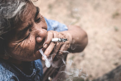 Midsection of man smoking cigarette