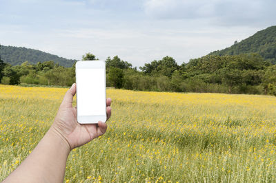 Close-up of woman holding apple on field