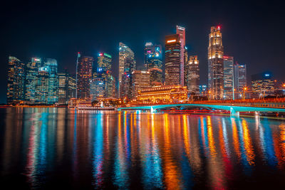 Illuminated buildings against sky at night