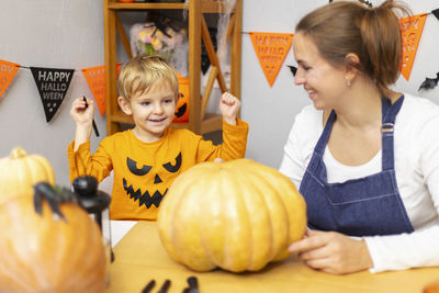High angle view of boy with pumpkin