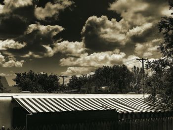 Roof of building against cloudy sky