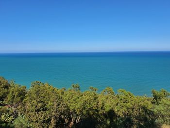 Scenic view of sea against clear blue sky