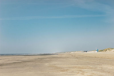 Scenic view of beach against clear blue sky