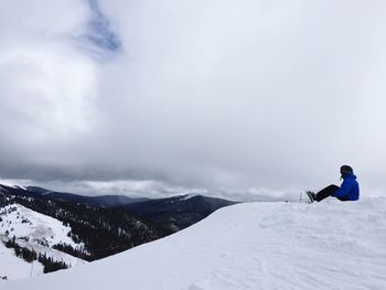 Tourists on snow covered mountain