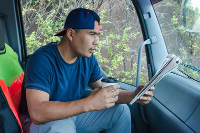 Man sitting in car