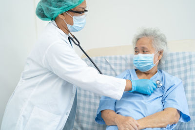 Doctor examining patient in hospital