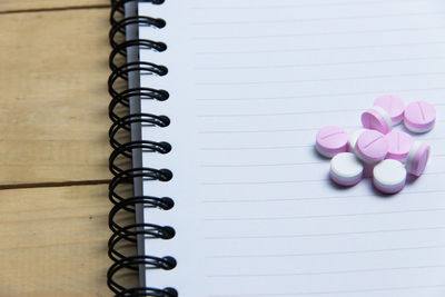 Close-up of book and pills on table