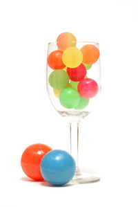 Close-up of multi colored balloons against white background