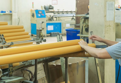 Person holding umbrella in factory