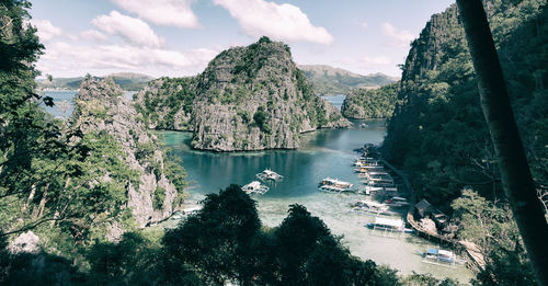 High angle view of bay and trees against sky