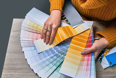 High angle view of woman reading book on table