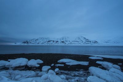 Scenic view of frozen lake against sky