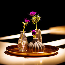 Close-up of purple flower in vase on table