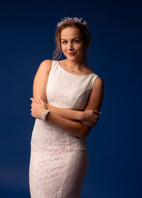 Portrait of a smiling young woman against blue sky