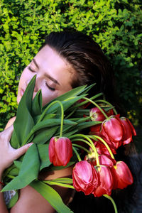 Portrait of woman with red flower