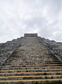 Low angle view of old building against cloudy sky