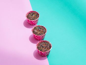 High angle view of candies on table against blue background