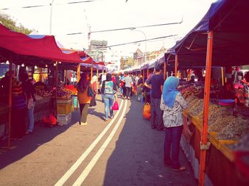 People walking on road in market