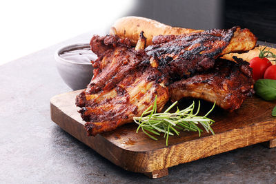 Close-up of meat on cutting board over white background