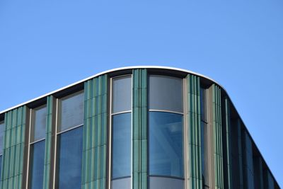 Low angle view of modern building against clear blue sky