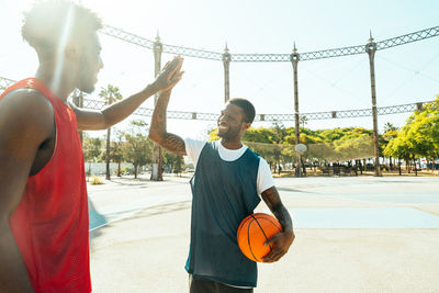 Rear view of woman playing basketball