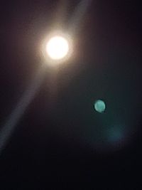 Low angle view of moon in dark sky