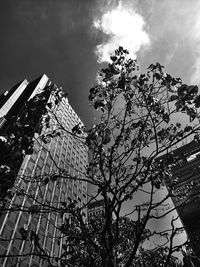 Low angle view of modern building against cloudy sky