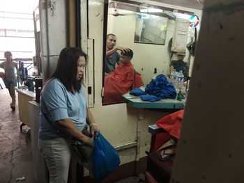 View of people sitting in corridor