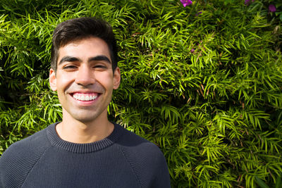 Portrait of a smiling young man standing outdoors