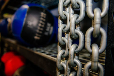 Close-up of chain hanging by shelf