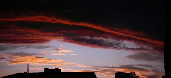 Low angle view of silhouette buildings against sky during sunset