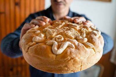 Midsection of man holding bread