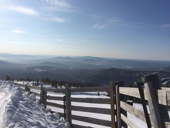 Scenic view of snowcapped mountains against sky during winter