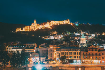 Illuminated buildings in city at night