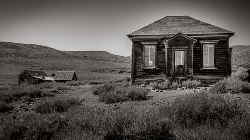 Abandoned house on field against sky