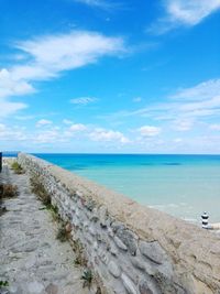 Scenic view of beach against blue sky