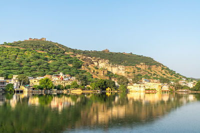 Scenic view of townscape by buildings against clear sky