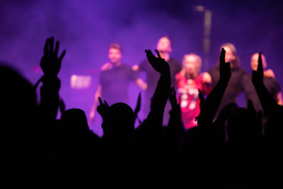 Group of silhouette people at music concert