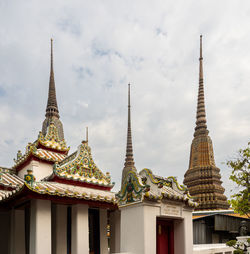 The sky is the backdrop for the golden towers of the wat pho temple in bangkok, thailand.
