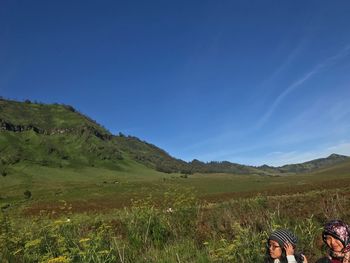 Scenic view of landscape against blue sky