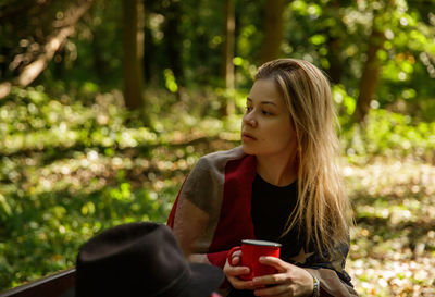 Young woman using mobile phone while standing outdoors