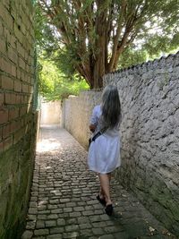 Rear view of woman standing by plants