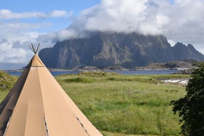 Scenic view of land and mountains against sky