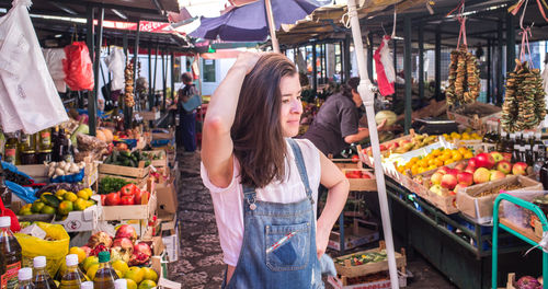 Woman looking away while standing at market