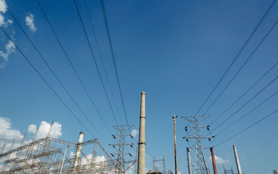 Low angle view of power lines against blue sky