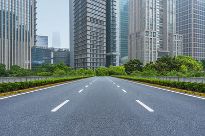 Digital composite image of city street and modern buildings